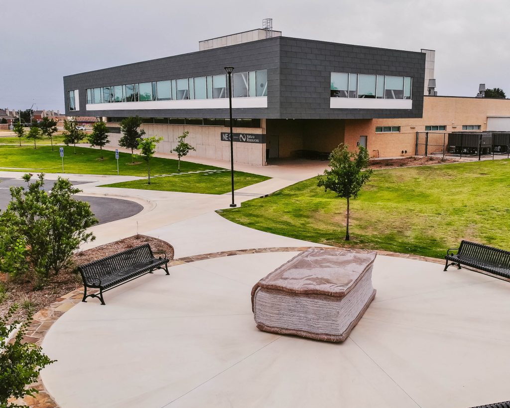 Natural stone book sculpture installed outside the Dillard Science and Engineering Research Center at Abilene Christian University.