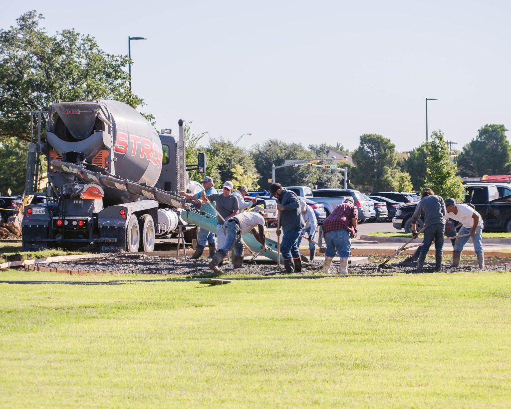 Construction crews prepare the installation site for The Book natural stone sculpture at Abilene Christian University.
