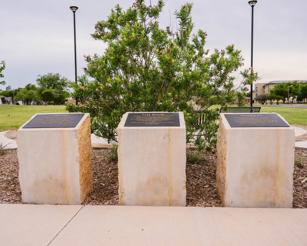 Interpretive plaques for The Book natural stone sculpture displayed at Abilene Christian University, providing project and artist information.