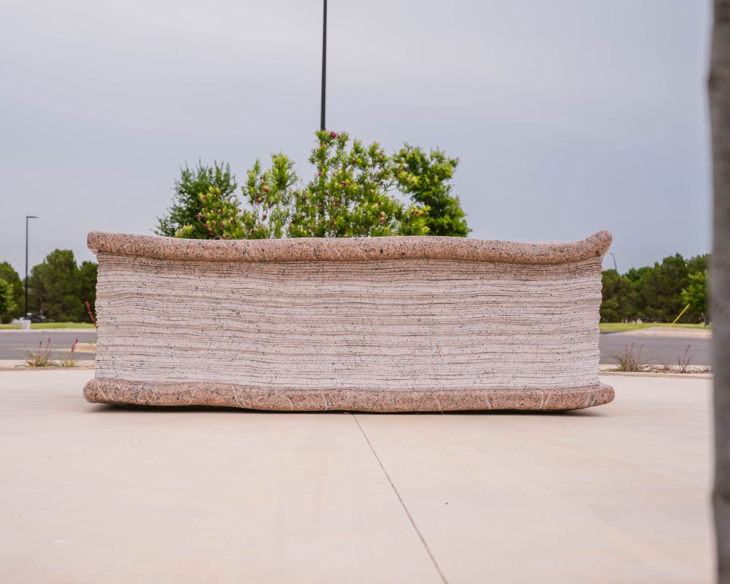 Side view of The Book natural stone sculpture at Abilene Christian University, highlighting detailed carved page edges and stone craftsmanship.